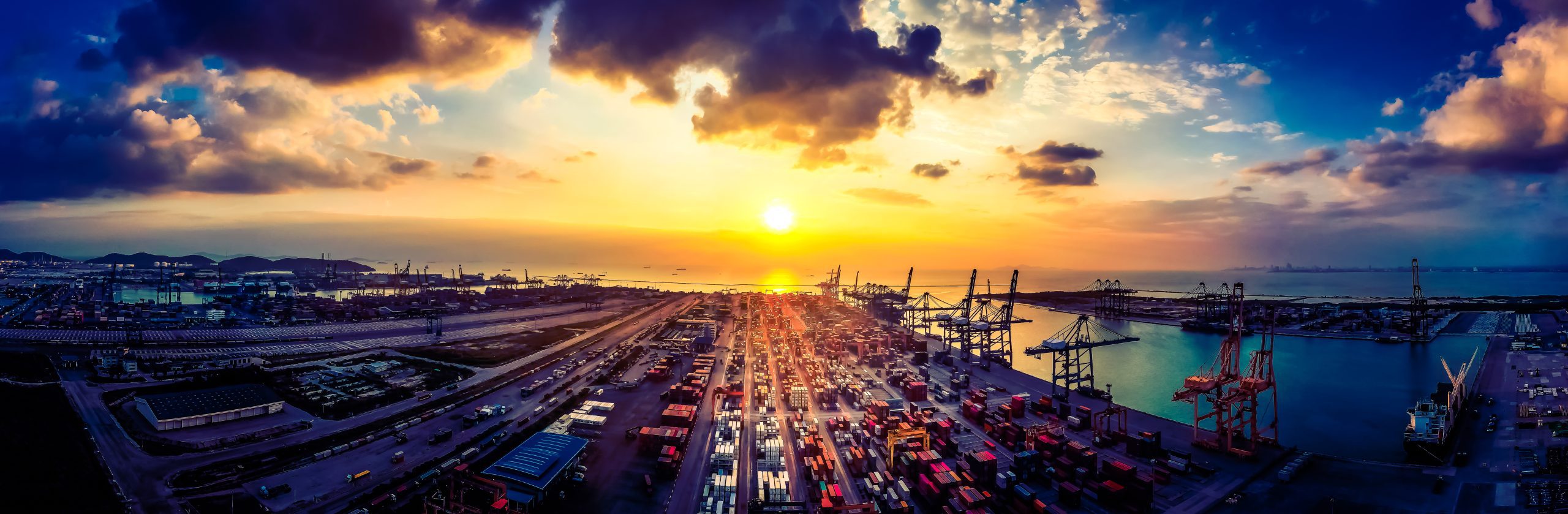 Image of sunset over a container port