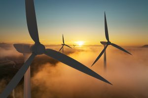 Wind turbine silhouette at sunrise, wind energy and nature concept. Indicating the renewables feasibility as an output of a renewables feasibility energy audit