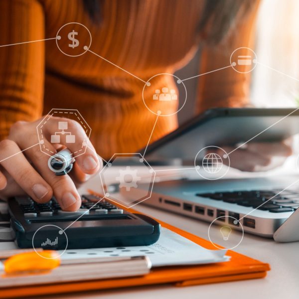 image showing person using calculator and laptop