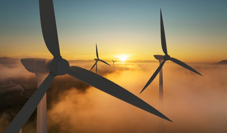 Wind turbine silhouette at sunrise, wind energy and nature concept. Indicating the renewables feasibility as an output of a renewables feasibility energy audit
